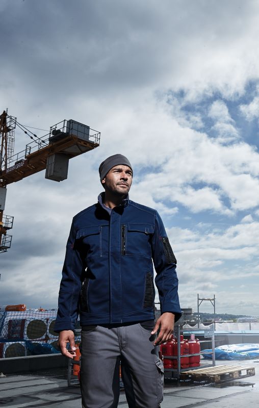 A roofer wears work clothes in cloudy weather.